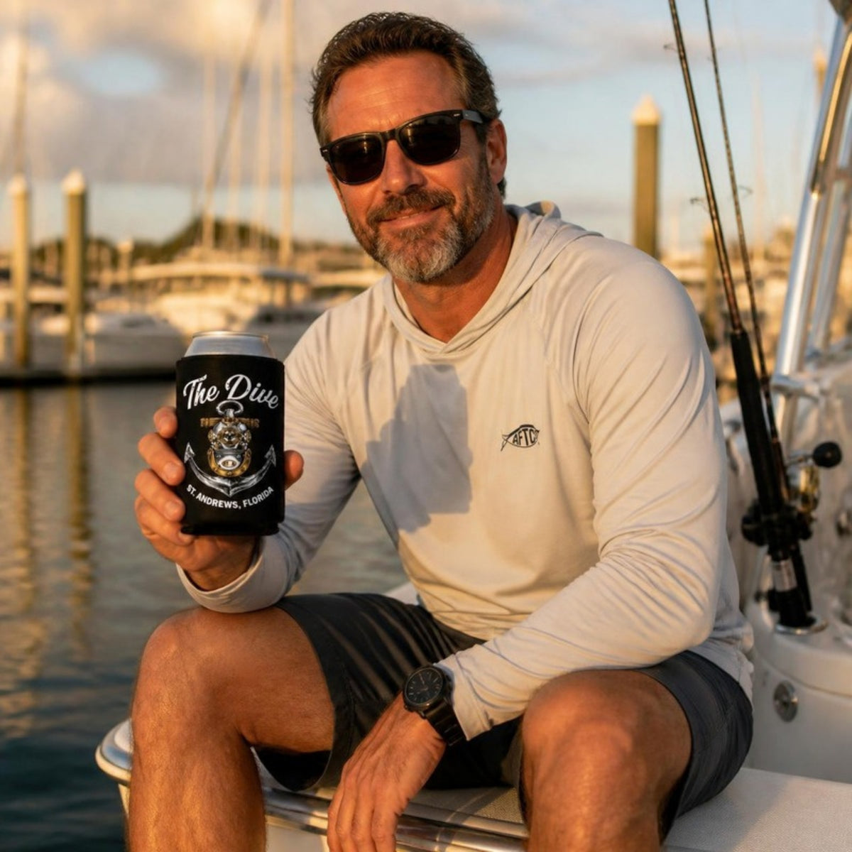 Man on a fishing boat with The Dive can koozie