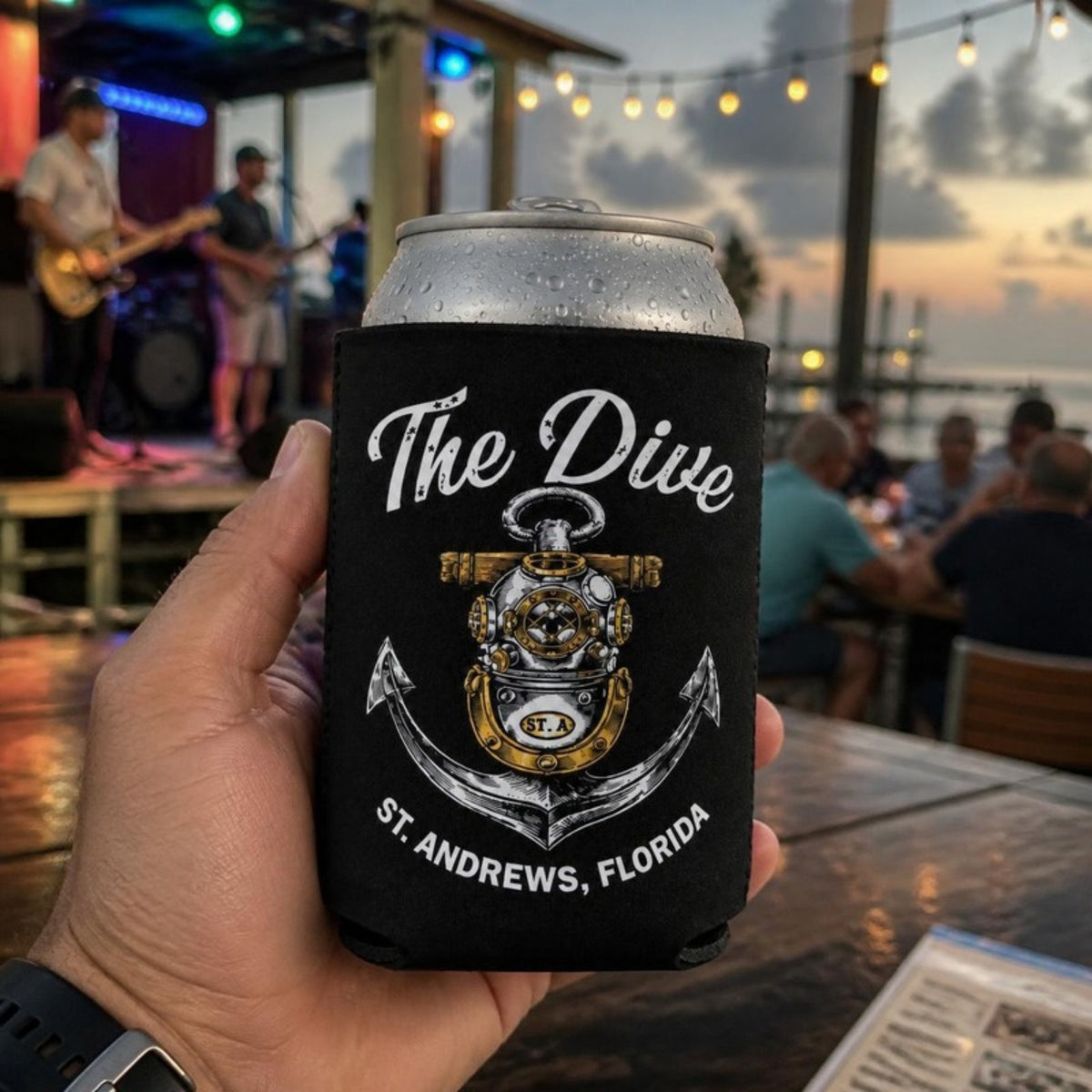 The Dive can koozie at a waterfront bar with live music