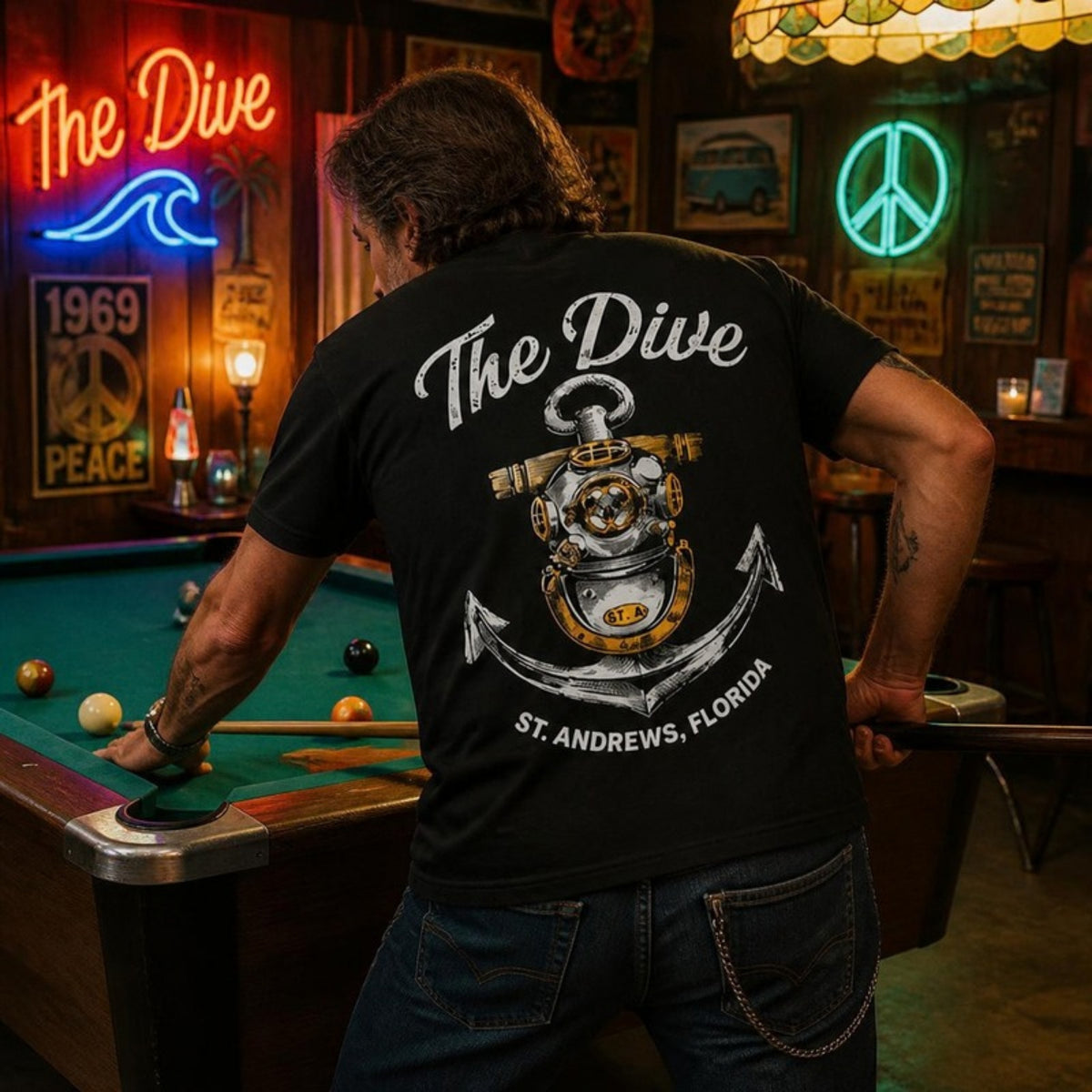 Man shooting pool in The Dive t-shirt