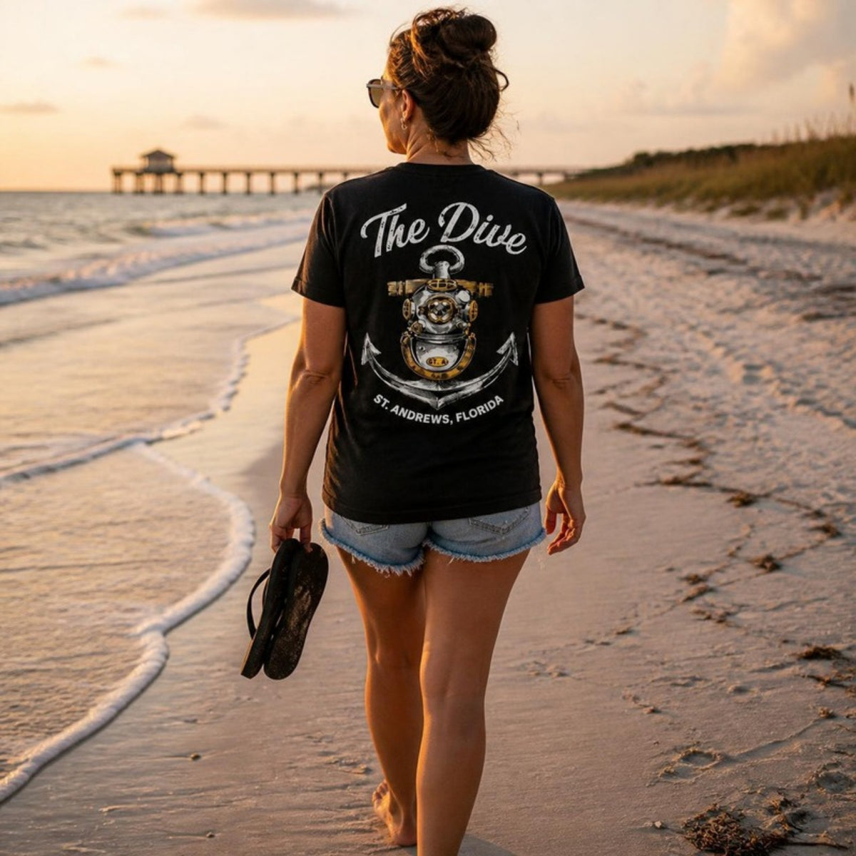 Woman walking the beach in The Dive t-shirt