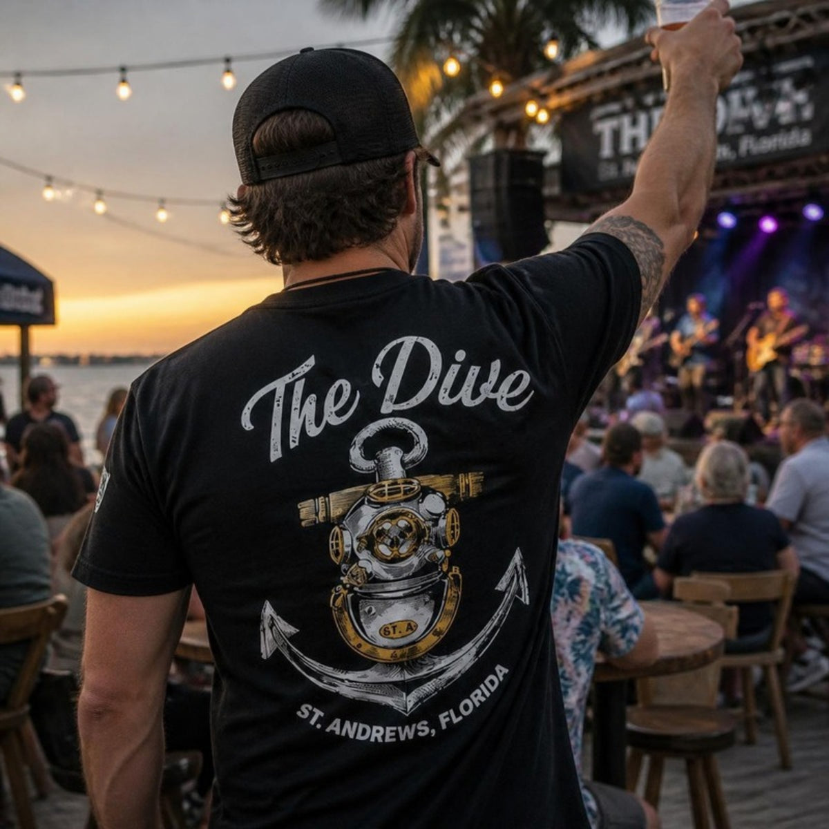 Man at a live music show in The Dive t-shirt