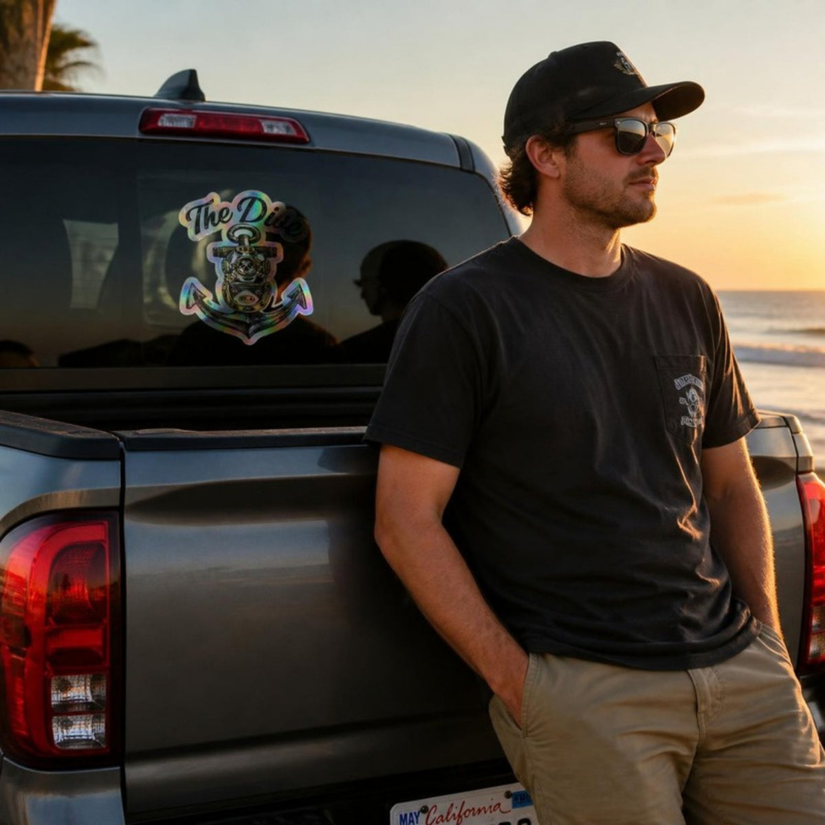 The Dive holographic sticker on a truck window at the beach
