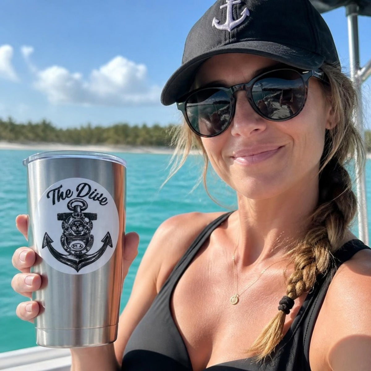 The Dive round sticker on a tumbler on a boat